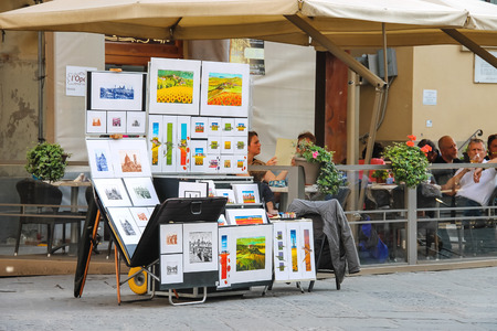 FLORENCE, ITALY - MAY 08, 2014: Equipment and drawings street artist outside restaurant in Florence, Italyのeditorial素材