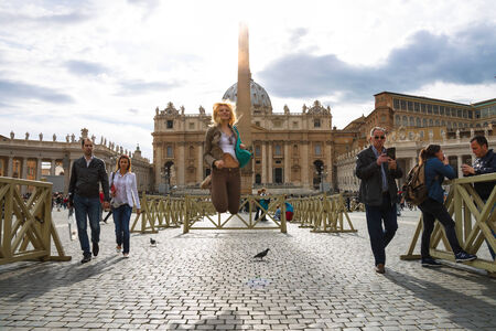 VATICAN CITY , ITALY - MAY 03, 2014: Happy girl jumping in the sunshine on the Saint Peter's Squareのeditorial素材