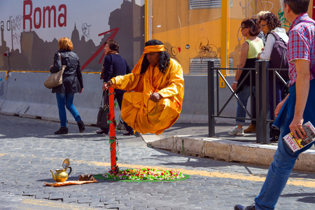 ROME, ITALY - MAY 04, 2014: Street performer in clothing monk demonstrates  trick of levitation in Rome, Italyのeditorial素材