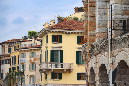 VERONA, ITALY - MAY 7, 2014: Urban buildings near the Arena of Verona - the place of annual festival operas in Verona, Italyのeditorial素材