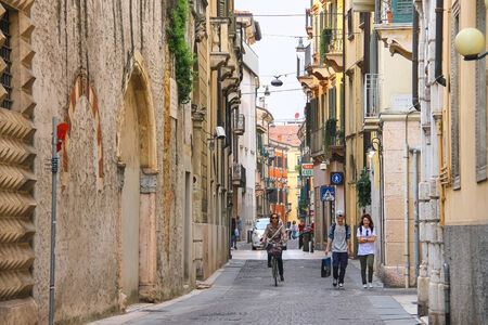 VERONA, ITALY - MAY 7, 2014: People on a narrow street in Verona, Italyのeditorial素材