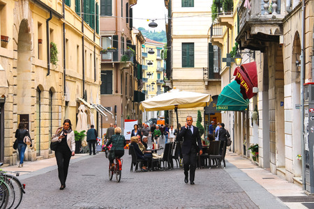 VERONA, ITALY - MAY 7, 2014: People on a narrow street in Verona, Italyのeditorial素材
