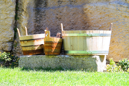 Wooden buckets and tubs in the courtyard of fortresses Guaita on Mount Titan. The Republic of San...