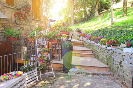 Flowers and bicycle in the external design of the outdoor restaurant in San Marinoの写真素材