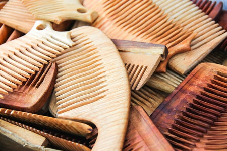 Lots of hand made wooden comb closeupの写真素材