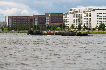Amsterdam, Netherlands - June 20, 2015: People in the boat on tours of the canals of Amsterdamのeditorial素材