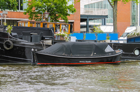 Amsterdam, Netherlands - June 20, 2015: Boats on a canal in Amsterdam. Netherlands