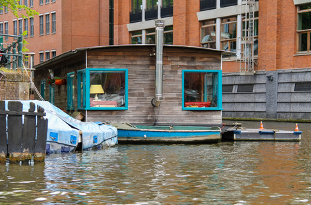 Houseboat on the waterfront canal in Amsterdamの写真素材