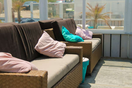 Soft sofas with colorfull pillows in the beach cafe terrace. Zandvoort, the Netherlandsの写真素材