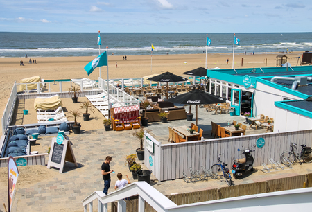 Zandvoort, the Netherlands- June 20, 2015: Two young man in beach cafe terrace near the North sea.のeditorial素材