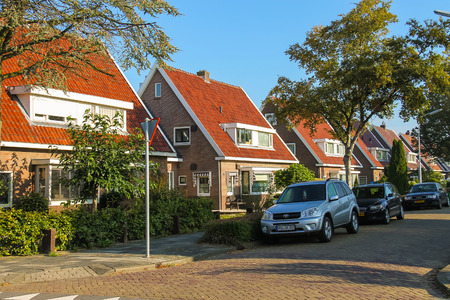 Zwanenburg, the Netherlands - Oct 03, 2015: Picturesque residential houses and parked autos in small town Zwanenburg in the Dutch province of North Hollandのeditorial素材