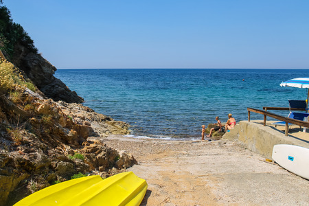 Elba Island, Italy - June 30, 2015: People taking a sunbath on the coast of the Tyrrhenian Sea on Elba Island.のeditorial素材