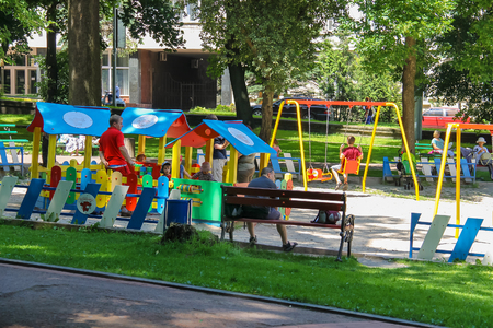 Lviv, Ukraine - July 5, 2014: People with children on playground in Ivan Franko park.のeditorial素材