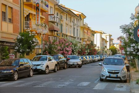 Viareggio, Italy - June 28, 2015: Parked cars on the street in city centre. Viareggio is the famous resort on the coast of the Ligurian Sea. Province Lucca, Tuscany region of Italyのeditorial素材