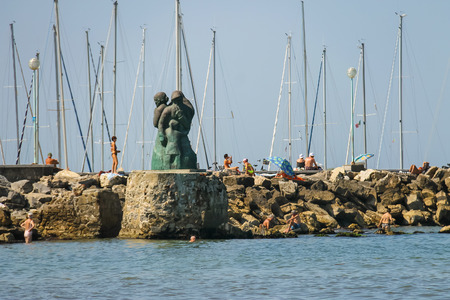 Viareggio, Italy - June 28, 2015: People resting near the monument to the sailors family by Inaco Biancalana. Viareggio is the famous resort on the coast of the Ligurian Seaのeditorial素材