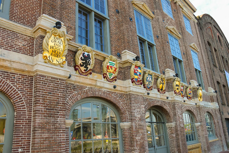 Amsterdam, the Netherlands -October 03, 2015: Old building with coat of arms on facade in the historic city center.のeditorial素材