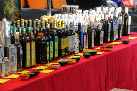 Utrecht, the Netherlands - February 13, 2016: Olive oil in bottles on the counter of street marketのeditorial素材