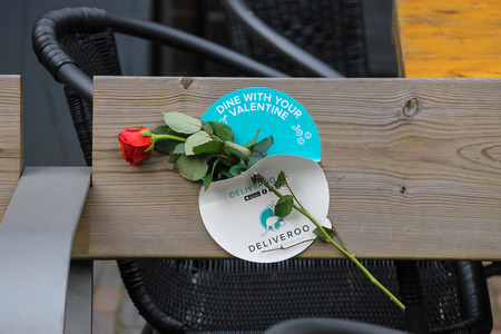 Utrecht, the Netherlands - February 13, 2016: Red rose on the wooden benchのeditorial素材