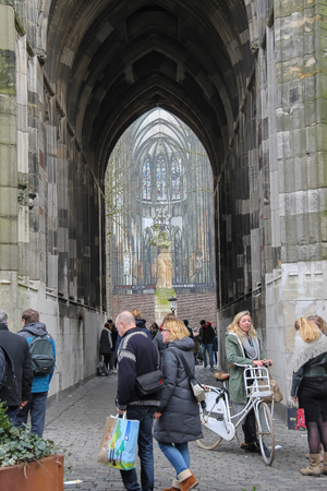 Utrecht, the Netherlands - February 13, 2016: People near arch passage of Cathedral Tower in historic city centreのeditorial素材