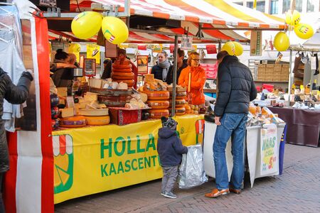 Utrecht, the Netherlands - February 13, 2016: People near shelves with cheese in the street marketのeditorial素材