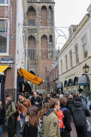Utrecht, the Netherlands - February 13, 2016: People walking in historic city centre. View to Dom Tower of the St. Martins Cathedralのeditorial素材