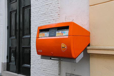 Utrecht, the Netherlands - February 13, 2016: Orange postbox on the wall of city buildingのeditorial素材