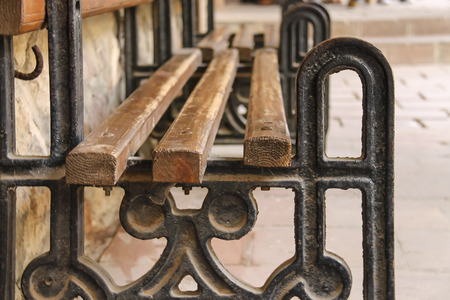 Old style bench with metal frame and wooden seatの写真素材