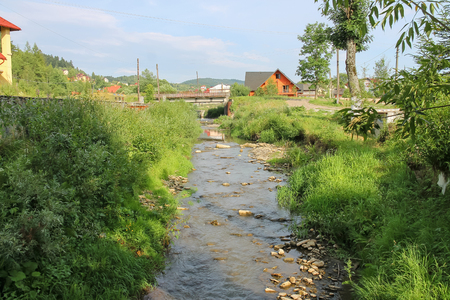 Narrow creek in small town of Carpathians, Ukraineの写真素材