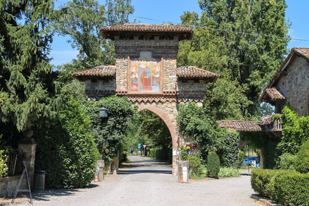 Grazzano Visconti, Italy - August 07, 2016: Medieval stone arch with religious paintingsのeditorial素材