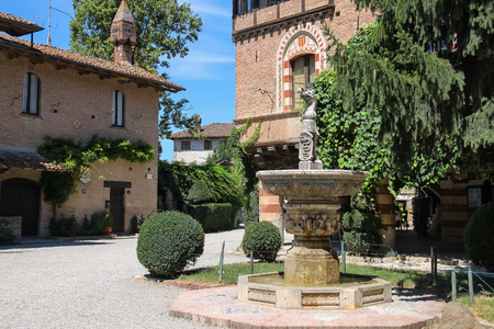 Grazzano Visconti, Italy - August 07, 2016: Fountain in the courtyard of ancient castle in Grazzano Visconti, Italyのeditorial素材