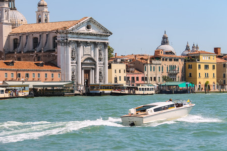 Venice, Italy - August 13, 2016: Tourist boats opposite the Church of Santa Maria del Rosario (Gesuati). View from Giudecca Canalのeditorial素材
