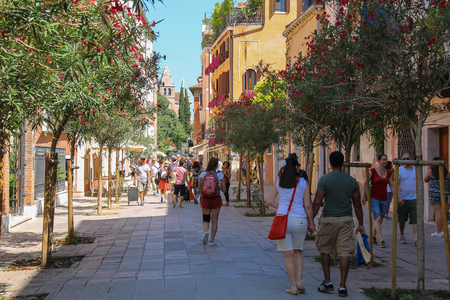 Venice, Italy - August 13, 2016: Tourists walking in street of old cityのeditorial素材