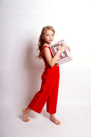 Pretty young kid girl in gray dress.Isolated studio shotの写真素材