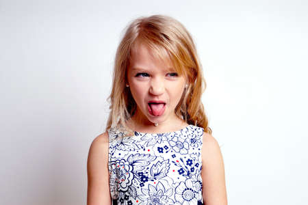 Pretty young kid girl in gray dress.Isolated studio shotの写真素材