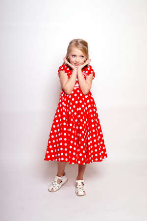 Pretty young kid girl in gray dress.Isolated studio shotの写真素材