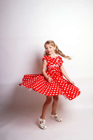 Pretty young kid girl in pink dress.Isolated studio shotの写真素材