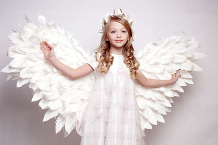 Pretty young lady with angel wings.Isolated studio shotの写真素材