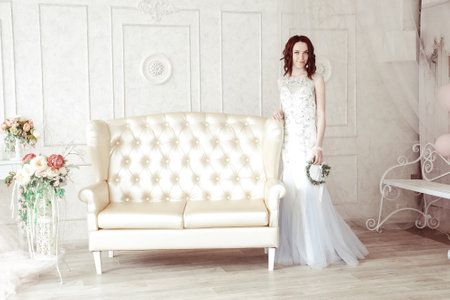 Beautiful young girl in evening dress posing at interior photo studio.Isolated portraitの写真素材