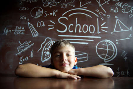 A small schoolboy prepares for studies.Isolated studio portraitの写真素材