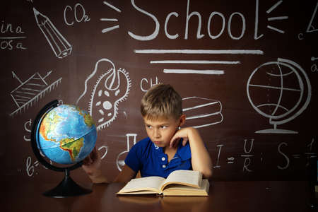 A small schoolboy prepares for studies.Isolated studio portraitの写真素材