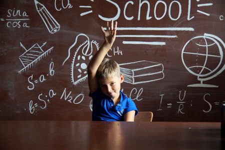 A small schoolboy prepares for studies.Isolated studio portraitの写真素材