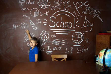 A small schoolboy prepares for studies.Isolated studio portrait