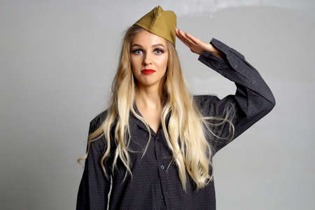 Luxurious girl posing in honor of the men's feast for the twenty-third of February.Isolated portraitの写真素材