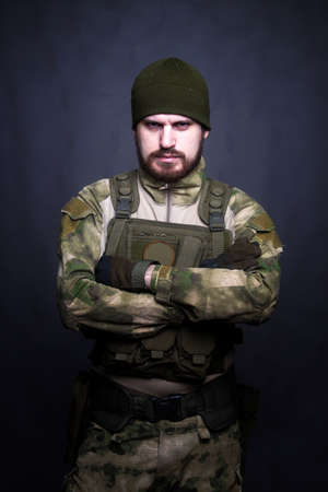 A soldier in camouflage clothing poses in a Studio.Indoor portraitの写真素材