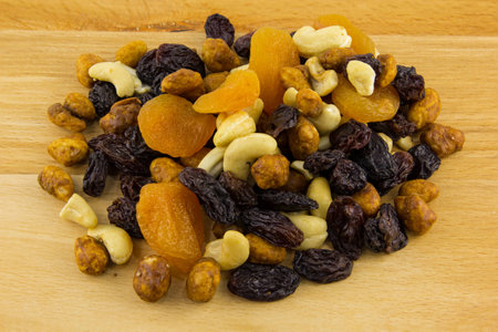 different dried fruits and nuts on wooden backgroundの写真素材