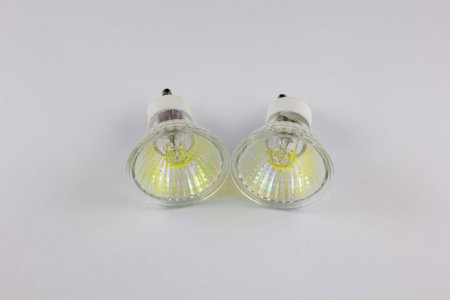 Pair of halogen bulbs with gu10 sockets on white backgroundの写真素材