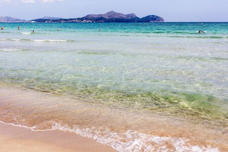 Summer beach with emerald crystal clear water and sand cakes left on the white sand beach. Playa de Muro, Mallorca, Balearic islands, Spain.の写真素材