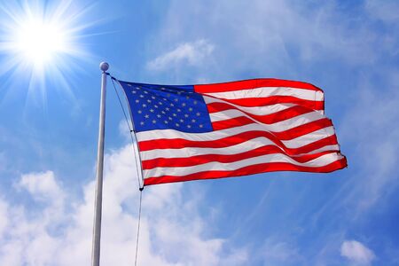 American flag against blue sunny skyの写真素材