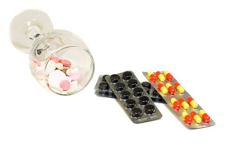 pills assortment with glass on white backgroundの写真素材