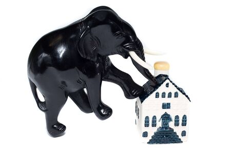 elephant step on house isolaten on whiteの写真素材